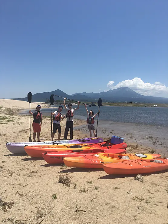 カヤックを前にポーズを決める人達