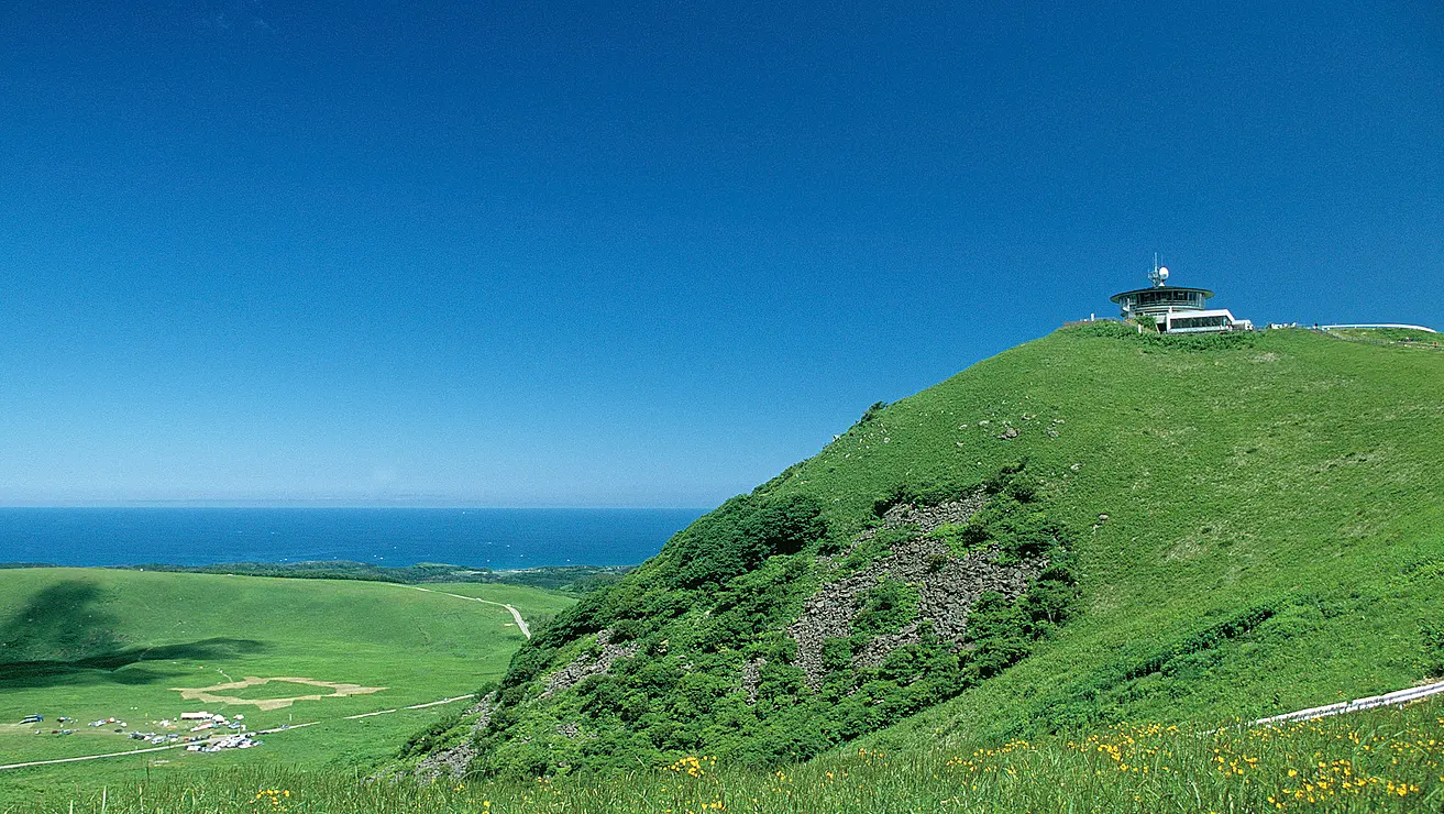 草地が広がる山と海