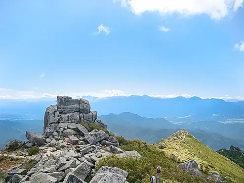 山頂から見た巨岩と南アルプスの眺め